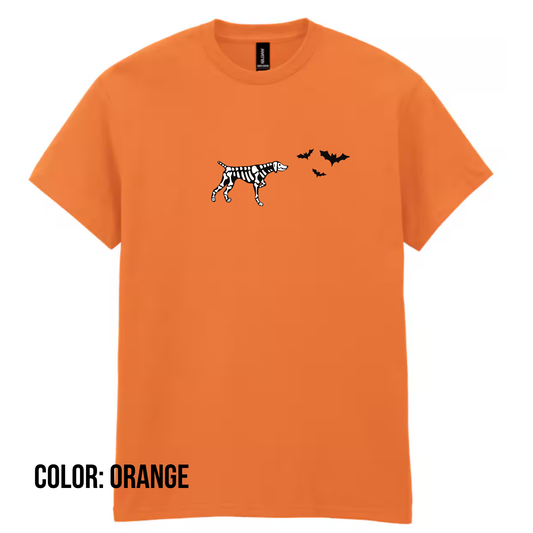 an orange t-shirt with a skeleton dog pointing at a group of flying bats